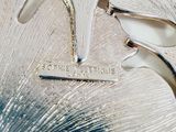 a close up of a silver vase with a tag on it