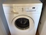a washer and dryer in the corner of a room
