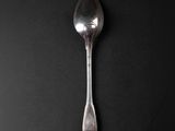 a spoon that is sitting on a black surface