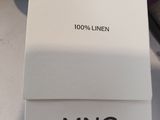 an image of a bag with a tag on it sitting on a table