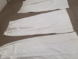 several white towels are lined up on the floor in a row
