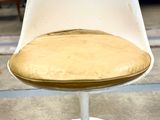 a white chair with a wooden seat in a room