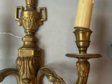 two candles that are on the wall next to each other
