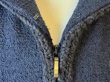 a close up of a sweater with a zipper on a mannequin head