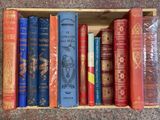 many books in a wooden box on the floor