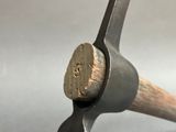 a hammer that has a wooden handle on it