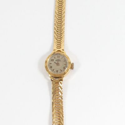 an image of a gold wrist watch with a chain around it