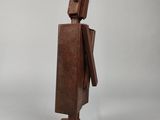 an image of a wooden sculpture of a man with a bird on it ' s head