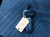 a car key and a car keychain on the seat of a car
