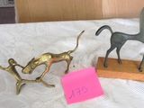 two figurines on a table with a note on it