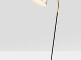 a brass and black floor lamp with a white shade