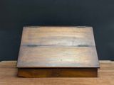 an old wooden box sitting on top of a wooden table