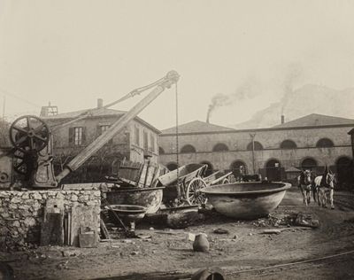 a black and white photo of a building with a crane