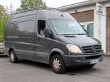 a black van parked in a parking lot next to a building