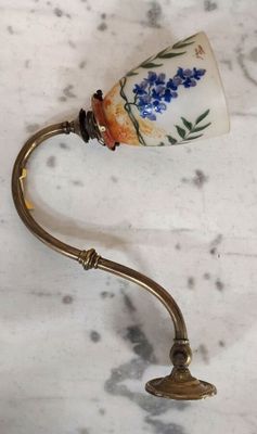 a small lamp that is on a table with a handle