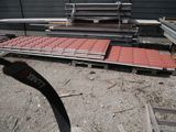 a pile of red bricks on the ground next to a pile of metal