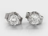 a pair of diamond earrings on a white background