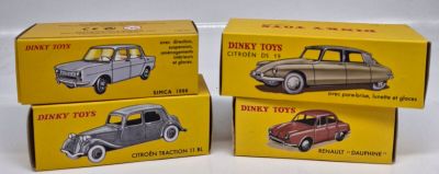three toy cars are sitting in boxes on a white surface