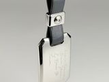 leather keychain with a silver plated key and a black leather strap