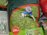 a bag of grass sitting on top of a cardboard box