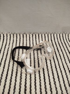 a pair of goggles sitting on a striped rug