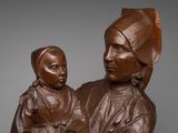 bronze statue of a woman holding a child in her arms