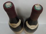 two bottles of wine sitting next to each other on a table