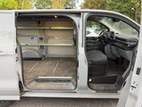 a white van with its doors open in a parking lot