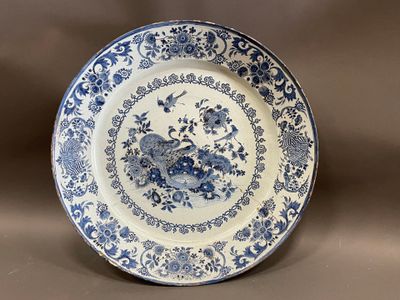 an old blue and white plate with flowers and birds on it