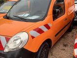 an orange van that is parked next to other cars