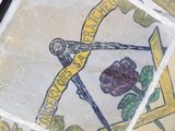 a close up of a painting of a flower on the ground