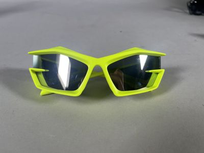 a close up of a pair of yellow sunglasses on a table