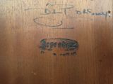 a close up of a piece of wood with writing on it
