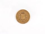 an old gold coin on a white surface with a white background