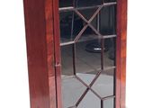 an image of a small wooden cabinet with a glass door