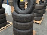 tires stacked on pallets in a warehouse with pallets of pallets in the background