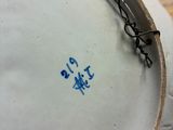 a white plate with blue writing on it on a wooden table
