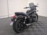 a black motorcycle that is parked on a checkered floor