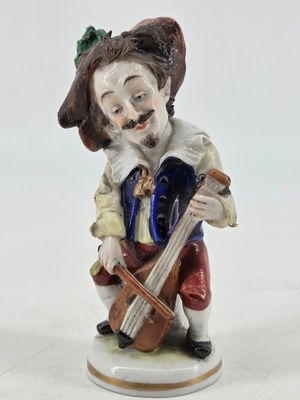 a figurine of a man playing a violin