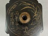 a black and gold plate with writing on it