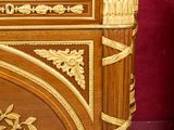 a wooden chest with a marble top on a table