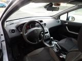 the interior of a small car with a steering wheel and dashboard