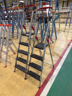 many ladders that are sitting on the floor in a gym