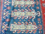 an image of a blue and red rug with a pattern on it