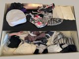 a box full of underwear and a hat on a table