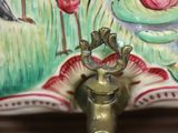 a bird that is sitting on top of a faucet