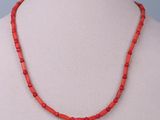 a red beaded necklace on a mannequin mannequin mannequin mannequin mannequin mannequin mannequin mannequin mann