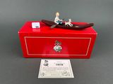a small figurine of a man in a boat on a red box