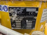 a close up of a yellow fire hydrant with a sign on it