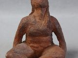 statue of a woman sitting in a yoga position